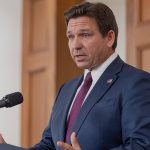 Ron Desantis Stands At Podium.jpg