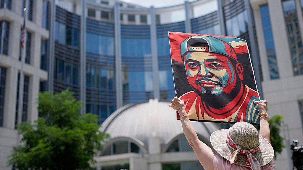 Woman Holds Kilmar Abrego Garcia Protest Sign.jpg