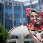 Woman Holds Kilmar Abrego Garcia Protest Sign.jpg